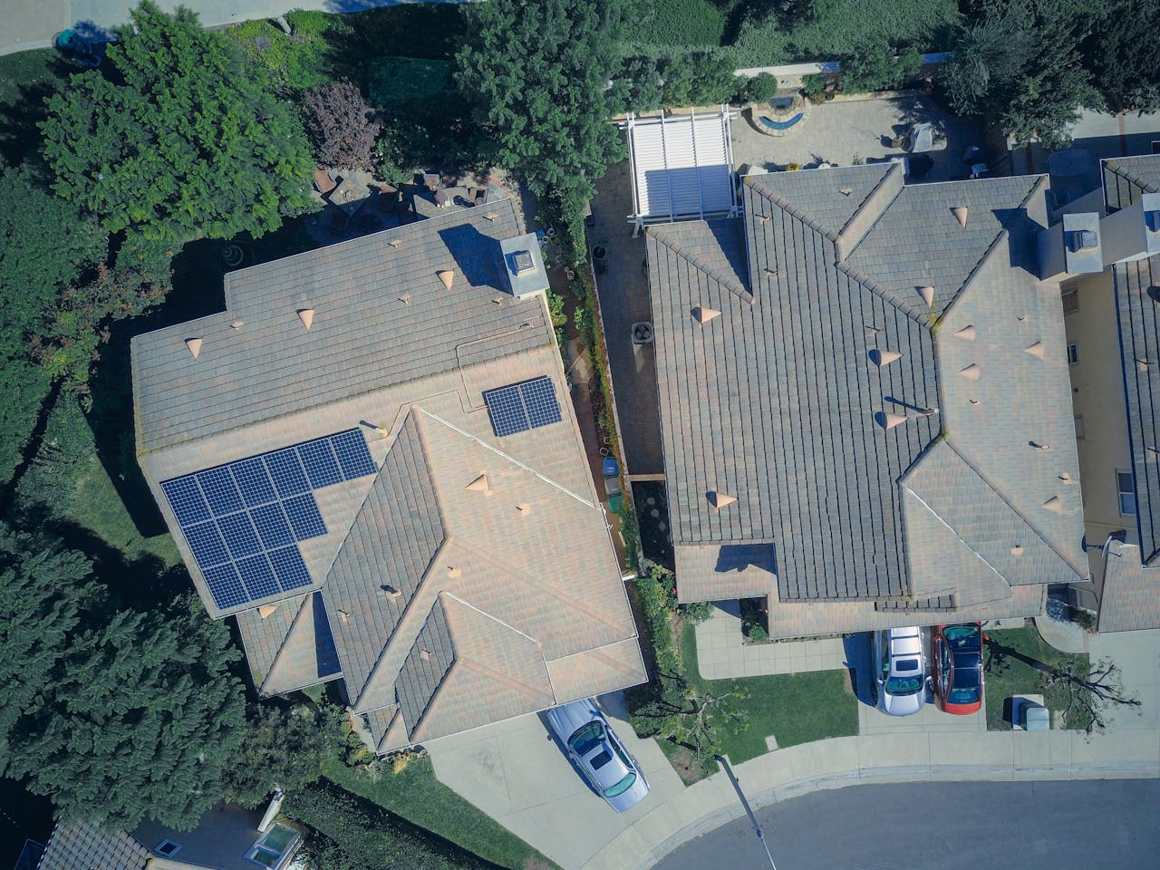 Services Top view of houses with solar panels, showcasing clean energy and sustainability.